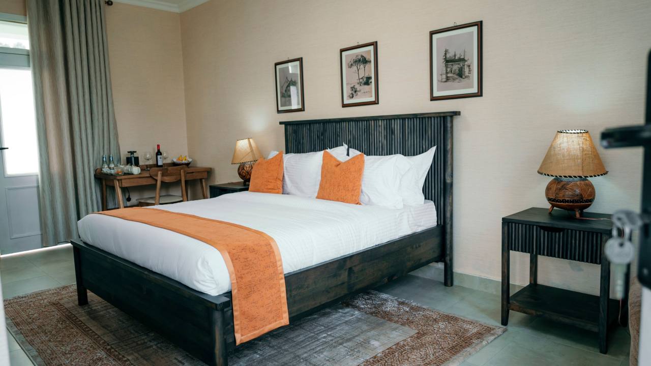 Your suite, after the trek. A quiet room, a made bed, and the gardens just outside the door.